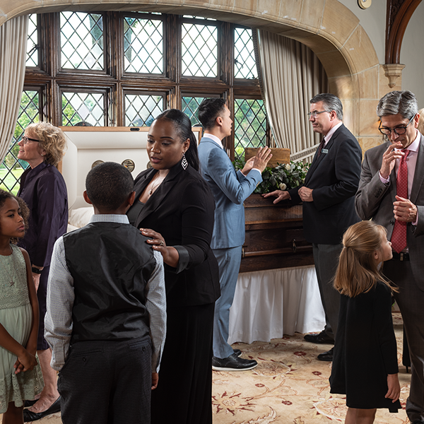 Family at calling hours with casket in the background
