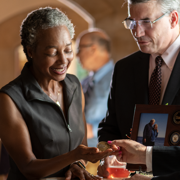 Directors sharing keepsake medallion