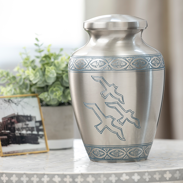 metal urn with doves on front