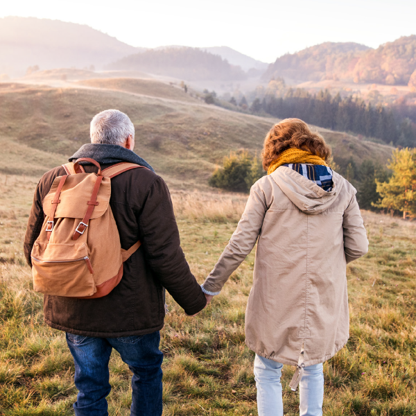 Couple walking in nature holding hands
